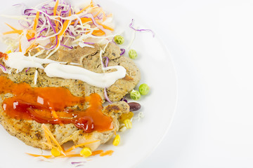 delicious grilled steak with peanut , garden pea, corn , carrot , cabbage with mayonnaise chilli and tomato sauce on the white dish on the white bakground isolate , close up steak,copy space