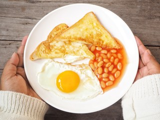 Woman eating english breakfast
