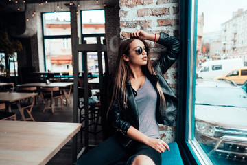 Beautiful girl in sunglasses posing on camera