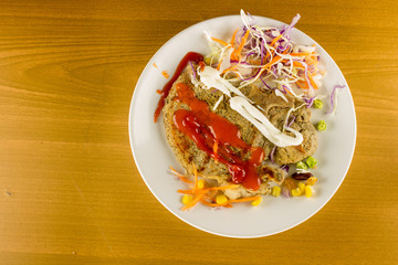 delicious grilled steak with peanut , garden pea, corn , carrot , cabbage with mayonnaise chilli and tomato sauce on the white dish , close up steak, copy space