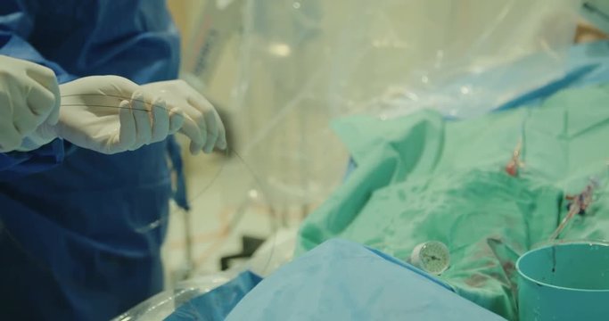 Surgeons inserting a catheter during a Cardiac catheterization in a hospital