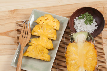 fresh slice of sweet pineapple on bamboo mat and salt