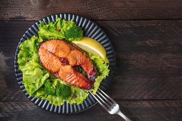 Grilled salmon steak with green lettuce and broccoli