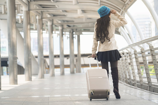 Asian woman holding luggage for travel