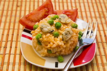 Seafood risotto with tomato and peas