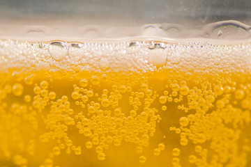 bubble beer close up / yellow background / water / drink