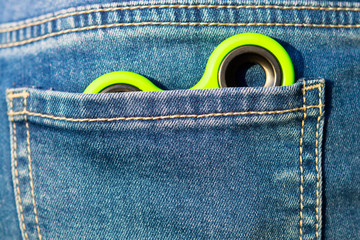 Green spinner in the child's jeans pocket, for playing with friends