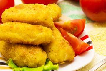 Croquettes with tomato on plate