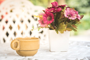 coffee cup on white table in the garden.