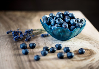 Blueberries in a bowl on a wooden table.