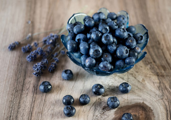 Blueberries in a bowl on a wooden table.