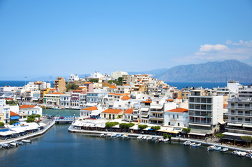 Fototapeta na wymiar View of Lake Voulismeni in Agios Nikolaos, Crete, Greece. A beautiful coastal city with colorful buildings.