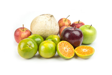 Orange, apple and coconut piled white background.
