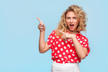 Blonde woman in red shirt making gesticulation