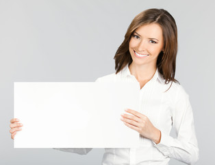 Businesswoman showing signboard, over grey