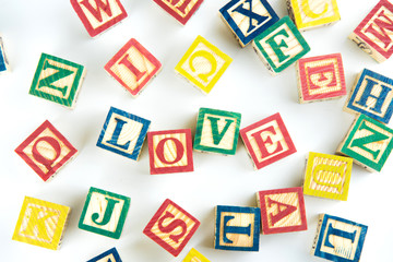 Fototapeta na wymiar wooden toy cubes are used to create the word love,Love concept or valentine day.