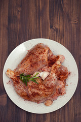 raw chicken with pepper and garlic on white plate