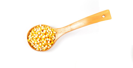 Organic corn drop out of wood spoon