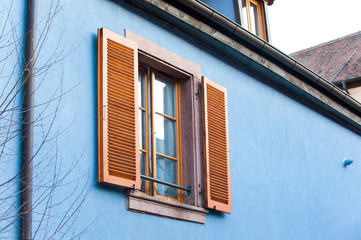 French provencal style blue house wall with windows. Alsace, France.