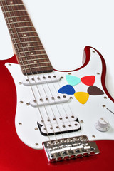 Obraz na płótnie Canvas Five colored picks on a guitar on a white background