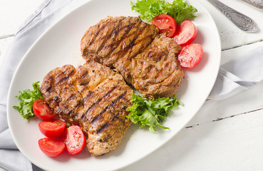 Grilled pork steak and vegetable salad