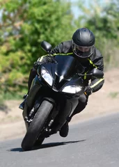 The biker on the black sports motorcycle in turn on speed