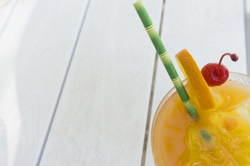Tropical cocktail with orange and cherry garnish