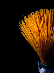 pasta raw on black color background,selective focus.