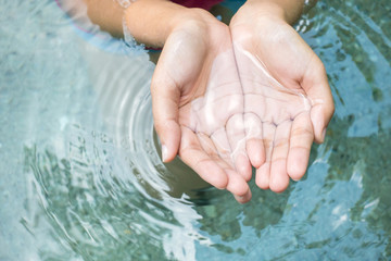 Clear natural water in woman hands. - 163229211