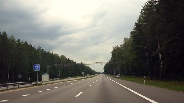 time lapse driving a car on a fast paced motorway in travel.  with sunny weather, blue sky and fluffy clouds time lapse.
