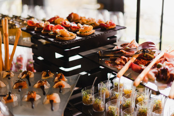 Catering banquet table at reception. Restaurant presentation, molecular gastronomy, haute cuisine, food consumption, party concept.