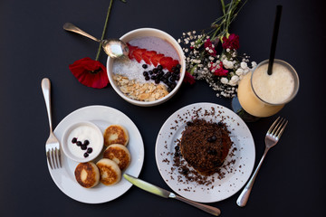 Cheesecake with sour cream, handmade. Pancakes on a black background. View from above