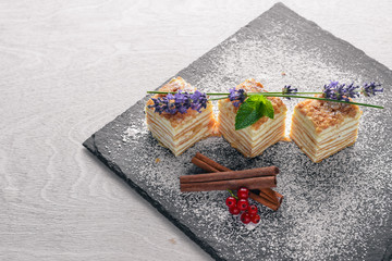 Layered cake with fresh berries. On a wooden background. Top review. Free space.