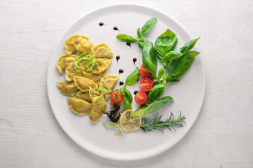 Dumplings with herbs. Ukrainian style. On a wooden background. Top review. Free space.