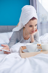 Girl in bed with a towel on her head
