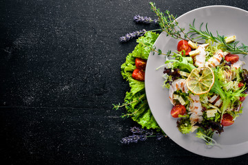 Fresh vegetables and grilled chicken salad. On a wooden background. Top review. Free space.