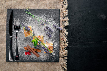 Layered cake with fresh berries. On a wooden background. Top review. Free space.