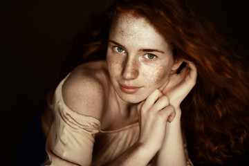 Obraz premium attractive tender freckled redhead woman looking at camera, isolated on black