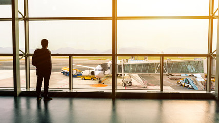 travel,Backpack tourists waiting flight on the gate in airport for summer trip.