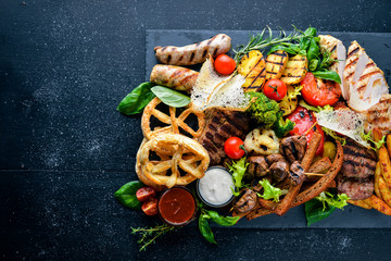 Meat assorted and cold appetizers. Ukrainian style. On a wooden background. Top review. Free space.
