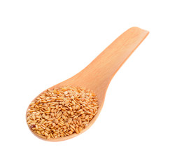 Golden flax seeds in wooden spoon  for spices close up isolated on a white background