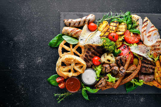 Meat assorted and cold appetizers. Ukrainian style. On a wooden background. Top review. Free space.