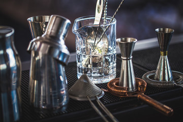 Classic bar cocktail shaker, bartender tools, a set of equipmen in blurred background