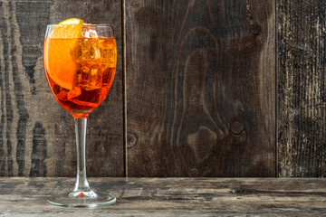 Aperol spritz cocktail in glass on wooden table
