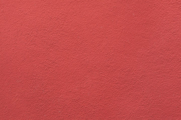 Red painted stucco wall.