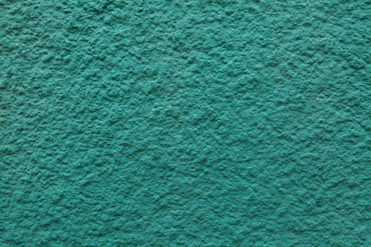 Emerald green painted stucco wall.