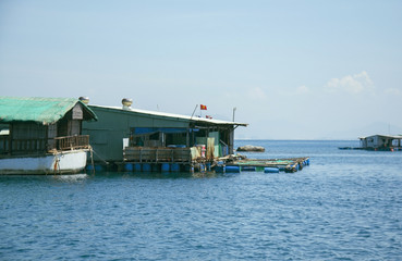 Fototapeta na wymiar Marine fish farm in Vietnam. Floating houses.