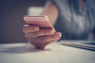 Close up of hand using smart phone. Caucasian business woman.