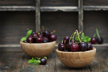 Fresh weet cherry and green mint on the wooden table