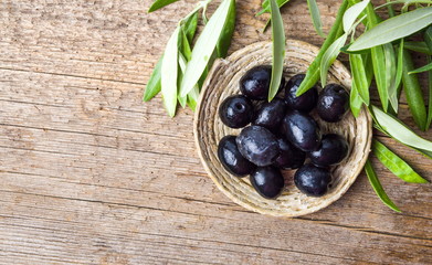 Dark olives on a wooden table
